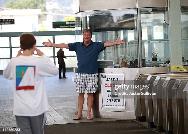 Greg Burrell from Florida, has his son Ben Burrell take a picture of him in front of a closure sign at the Bay Area Rapid Transit Millbrae station on...