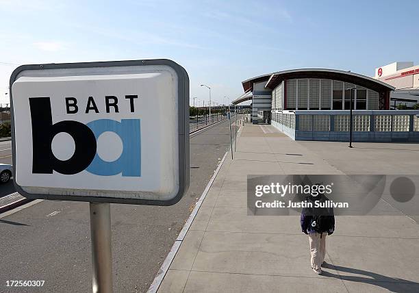 Lone person walks through an empty Bay Area Rapid Transit station on July 3, 2013 in San Bruno, California. For a third day, hundreds of thousands of...