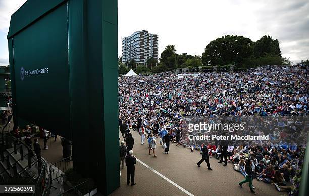 Tennis fans watch a giant TV screen showing Britain's Andy Murray beating Fernando Verdasco of Spain to reach the semi finals of the gentlemen's...