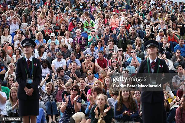 Tennis fans watch a giant TV screen showing Britain's Andy Murray beating Fernando Verdasco of Spain to reach the semi finals of the gentlemen's...