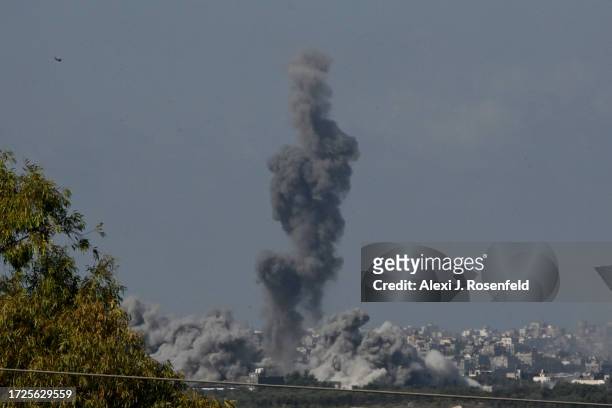 Smoke rises from buildings, viewed from the Israeli side of the border, as the Israeli military conducts a bombardment on October 15, 2023 in...