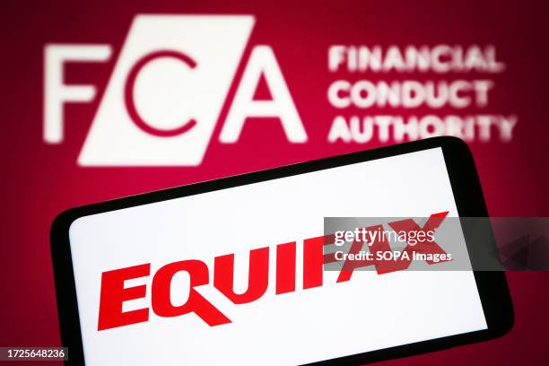 In this photo illustration, Equifax logo is seen on a smartphone and Financial Conduct Authority logo on a pc screen.