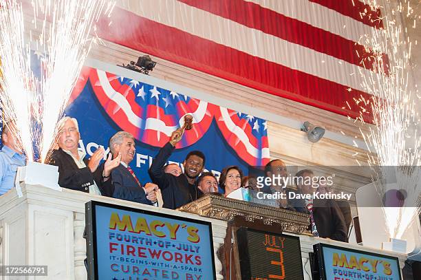 Usher and Macy's 4th Of July fireworks executive producer Amy Kule ring the NYSE closing bell at the New York Stock Exchange on July 3, 2013 in New...