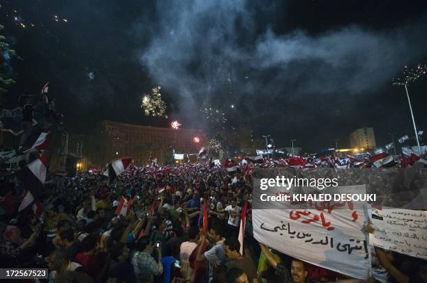 People celebrate at Tahrir Square after a broadcast by the head of the Egyptian military confirming that they will temporarily be taking over from...