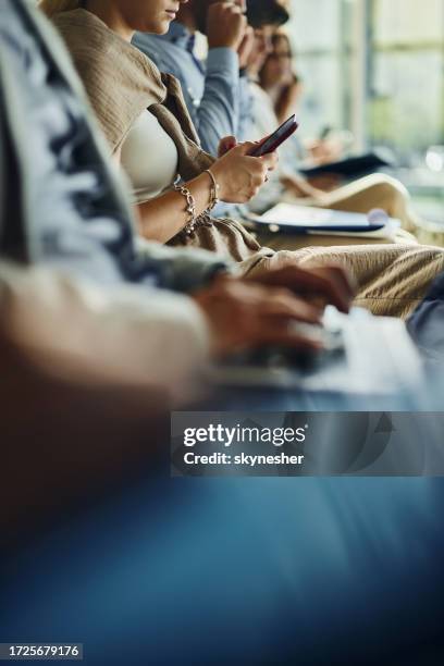 unrecognizable businesswoman using cell phone while waiting for job interview. - people in a line stock pictures, royalty-free photos & images