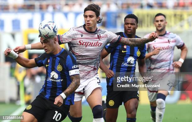 Lautaro Martinez of FC Internazionale competes for the ball with Riccardo Calafiori of Bologna FC during the Serie A TIM match between FC...