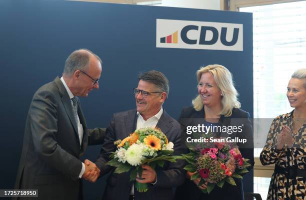 Friedrich Merz , leader of the German Christian Democrats , welcomes Boris Rhein , incumbent and lead CDU candidate in the state of Hesse, at CDU...