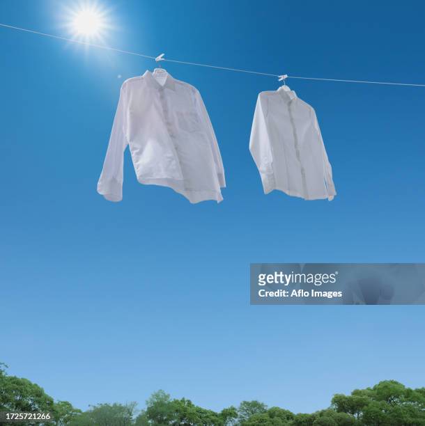 laundry drying up on washing line - white blouse stock-fotos und bilder