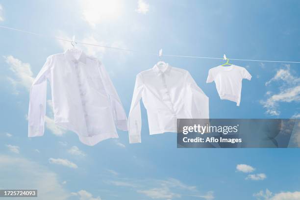 laundry drying up on washing line - white blouse stock-fotos und bilder