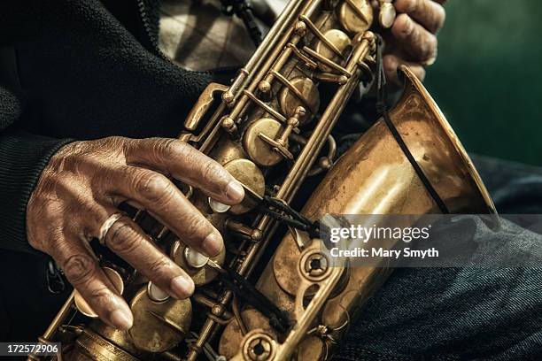 man playing the saxophone - sax stock-fotos und bilder