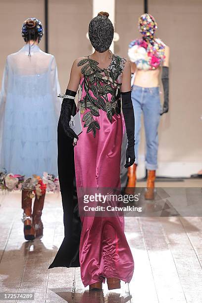 Model walks the runway at the Maison Martin Margiela Autumn Winter 2013 fashion show during Paris Haute Couture Fashion Week on July 3, 2013 in...