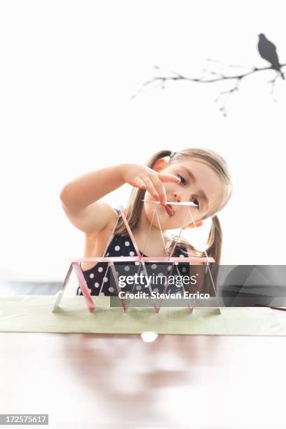 young girl building house of cards - house of cards stock pictures, royalty-free photos & images