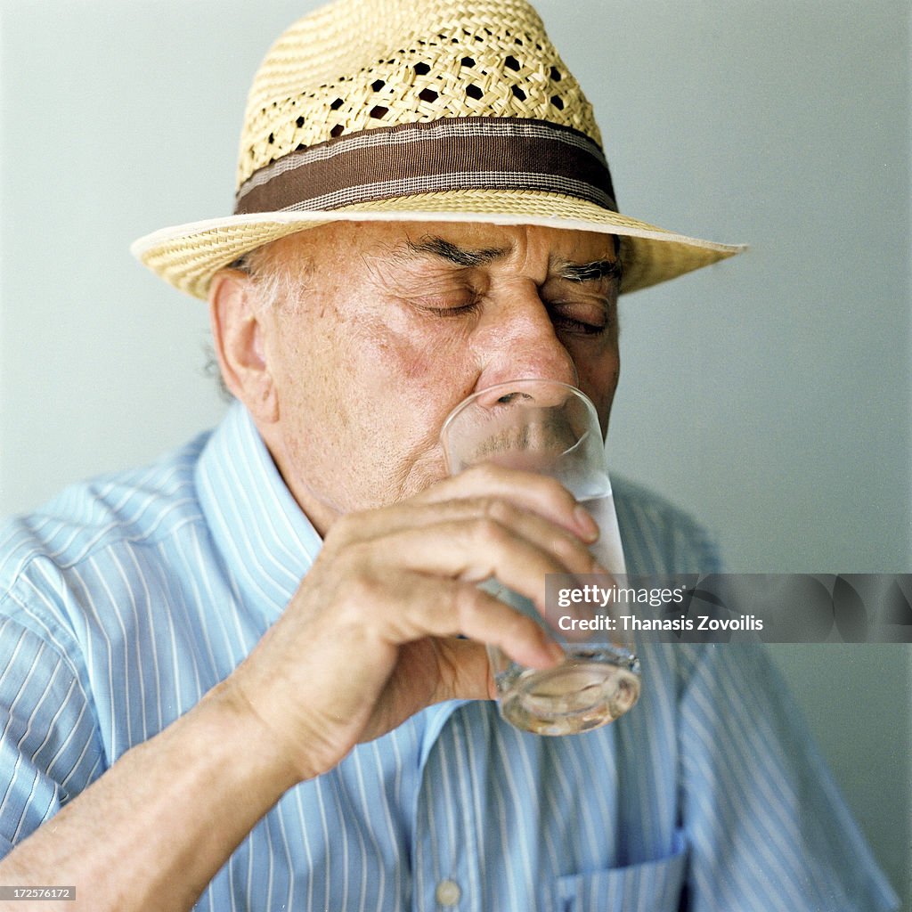 Portrait of a senior man drinking water