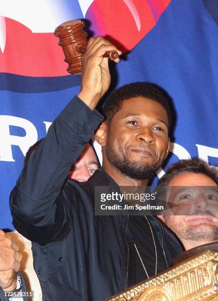 Singer Usher rings the closing bell at the New York Stock Exchange on July 3, 2013 in New York City.
