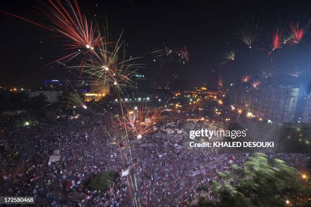 Fireworks light up the sky as Hundreds of thousands of Egyptians celebrate after Egytptian Defense Minister Abdel Fattah al-Sisi's speech announcing...