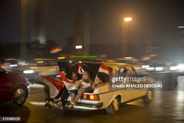 An Egyptian family celebrates in Cairo on July 3, 2013 after a broadcast confirming that the army will temporarily be taking over from the country's...