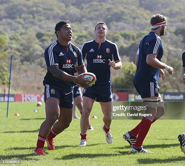 Manu Tuilagi of the Lions runs with the ball during a British and Irish Lions training session at Noosa Dolphins RFA on July 4, 2013 in Noosa,...