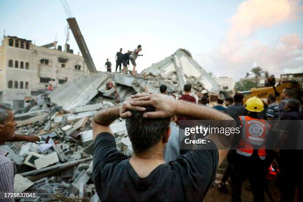 Graphic content / A man reacts as he watches recuers and civilians remove the rubble of a home destroyed following an Israeli attack on the town of...