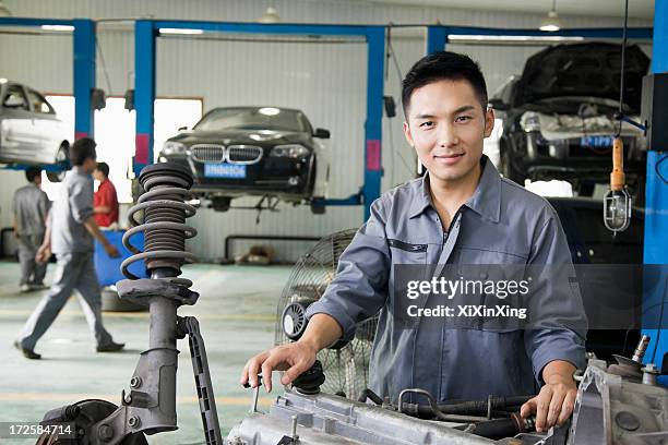 mechanic fixing car engine - mechanic uniform stock pictures, royalty-free photos & images