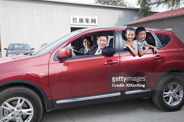 happy family looking out of a car - asian couple garage car stock pictures, royalty-free photos & images