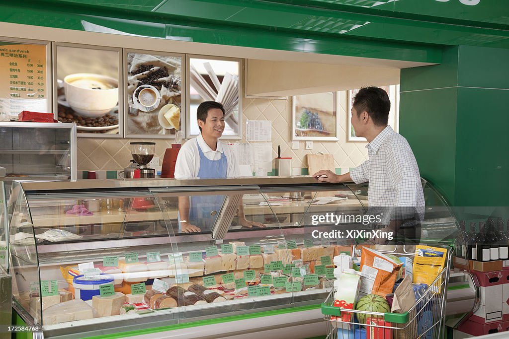 Sales Clerk assisting man at the Deli counter, Beijing