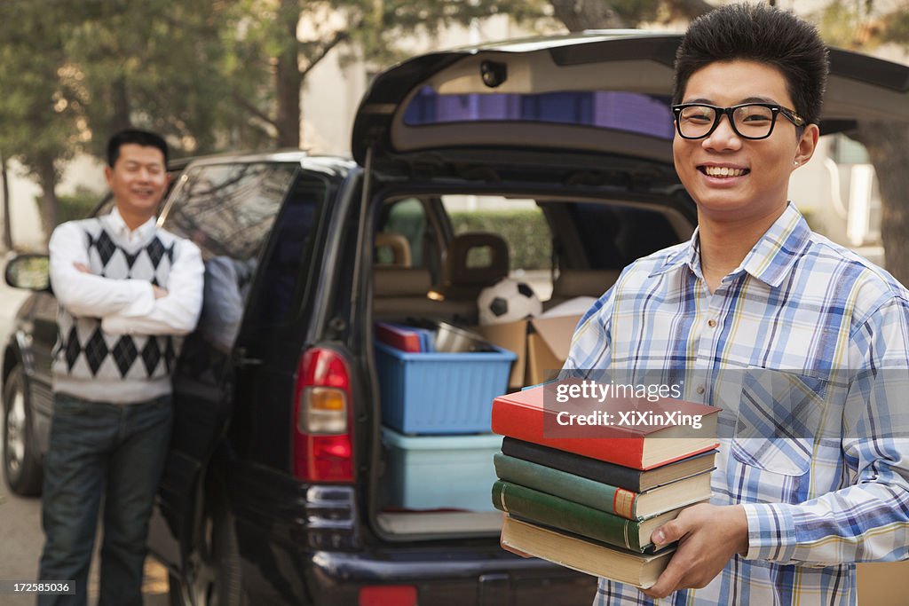 Boy unpacking car for college