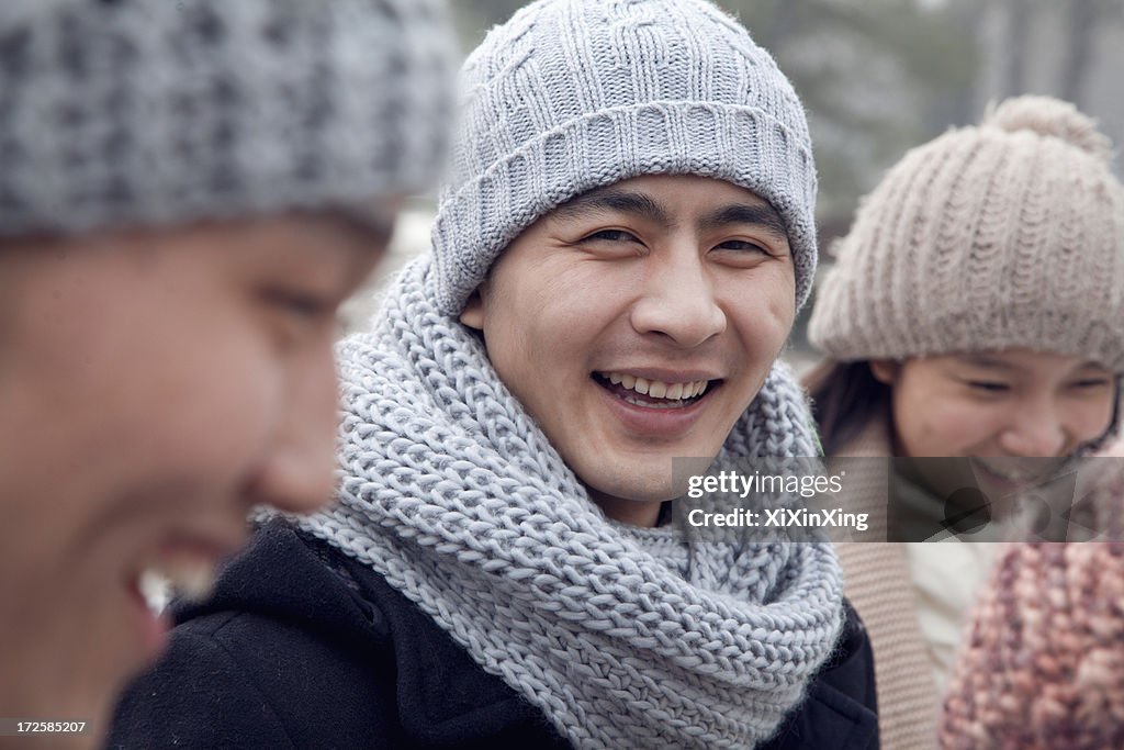Portrait of Young Man in Winter with Friends