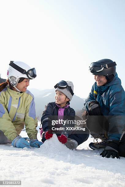 family playing in the snow - chinese father and son snow stock pictures, royalty-free photos & images