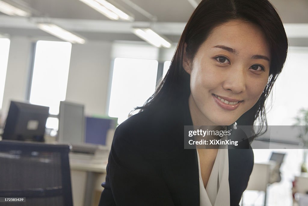 Portrait of smiling young businesswoman in the office