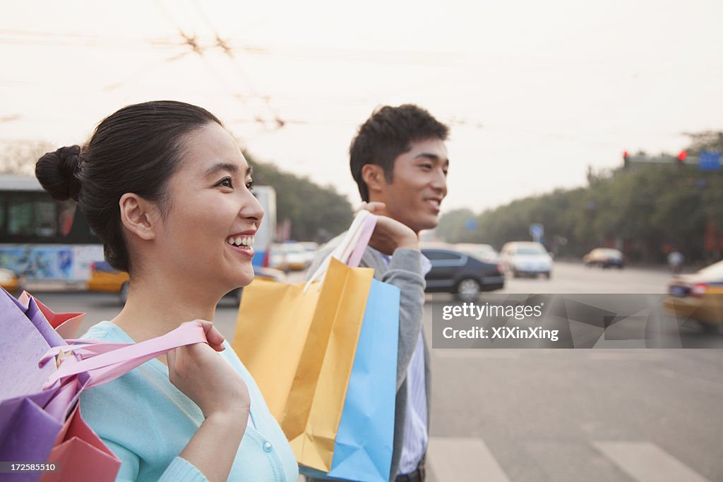 Young couple walking down the street with shopping bags in Beijing