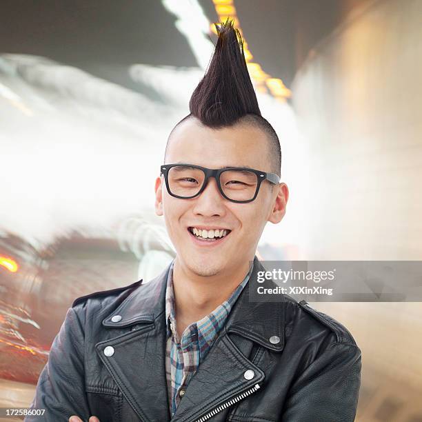 young man with punk mohawk smiling - capelli alla moicana foto e immagini stock