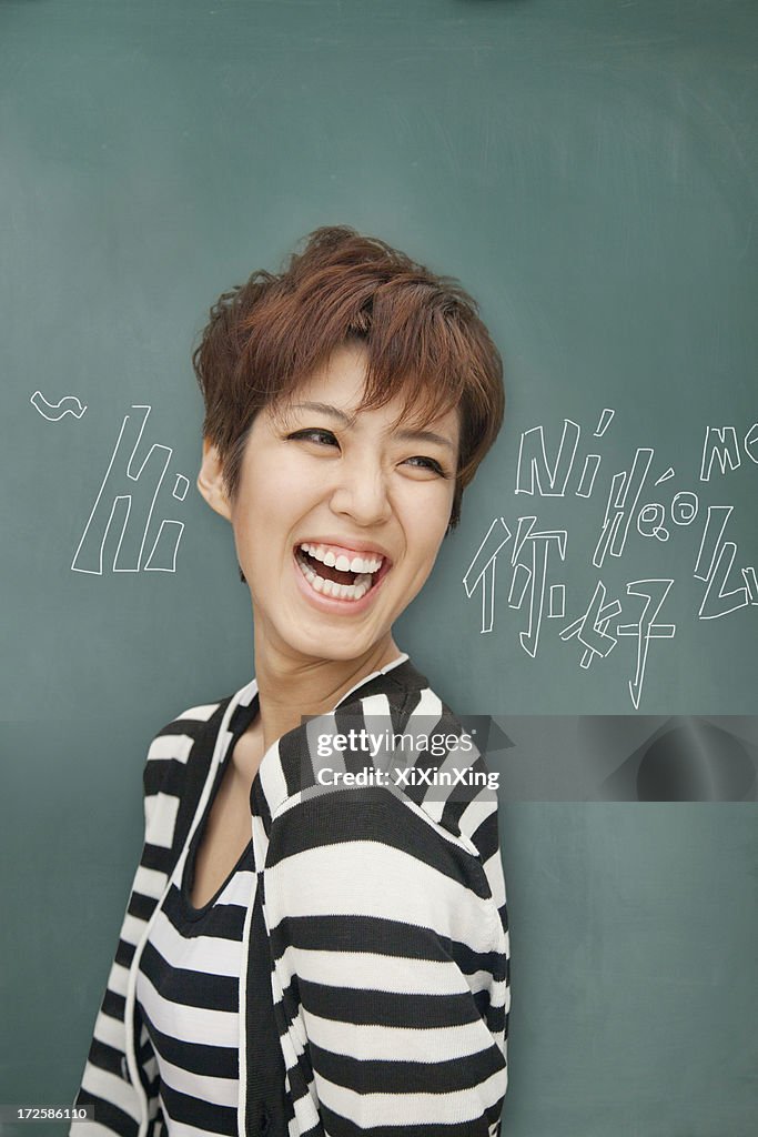 Portrait of bilingual woman in front of blackboard