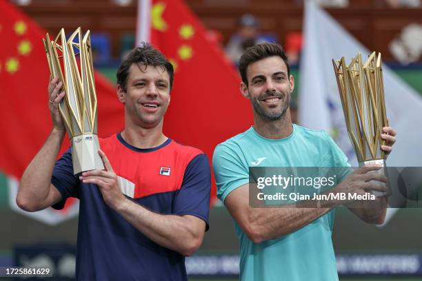 Marcel Granollers of Spain and Horacio Zeballos of Argentina pose with their trophy during the Award Ceremony after the men's doubles final match...