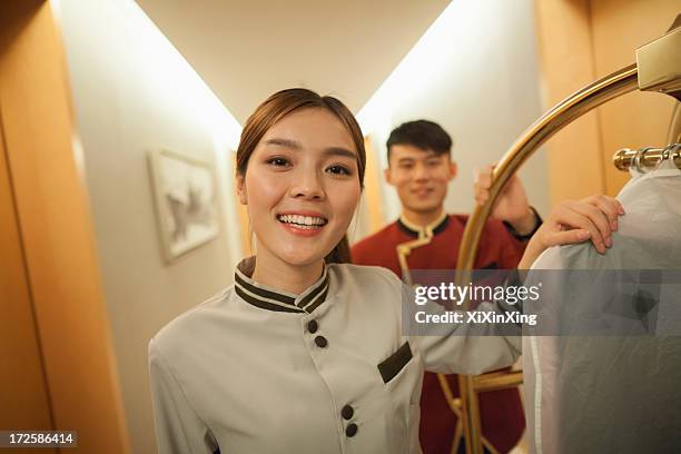 bellhops in the doorway smiling, portrait - hospitality worker stockfoto's en -beelden