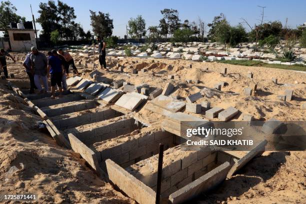 Graves are made ready to receive the new dead in the cemetery in Rafah, south of the Gaza Strip, near the Egyptian border on Octobers 15 amid the...