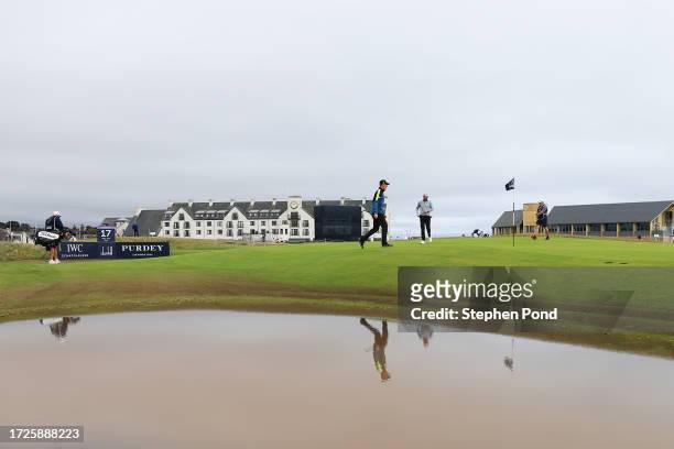 Grant Forrest of Scotland and Laurie Canter of England walk on the 16th green, as water sits on course, during Round Three on Day Five of the Alfred...