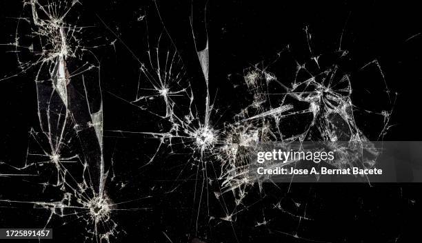 full frame of glass broken by the impact of a mobile phone screen. - scherben stock-fotos und bilder
