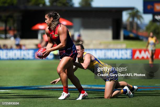 Eliza West of the Demons evades Emma Swanson of the Eagles during the 2023 AFLW Round 07 match between the West Coast Eagles and Naarm at Mineral...