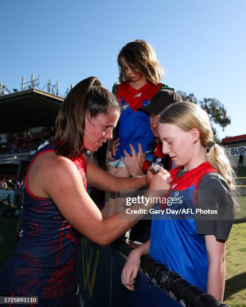 Kate Hore of the Demons signs an autograph during the 2023 AFLW Round 07 match between the West Coast Eagles and Naarm at Mineral Resources Park on...