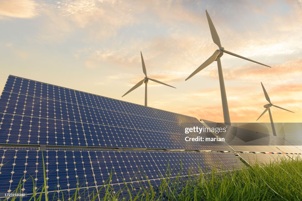 Solar panels and wind turbines under sunlight