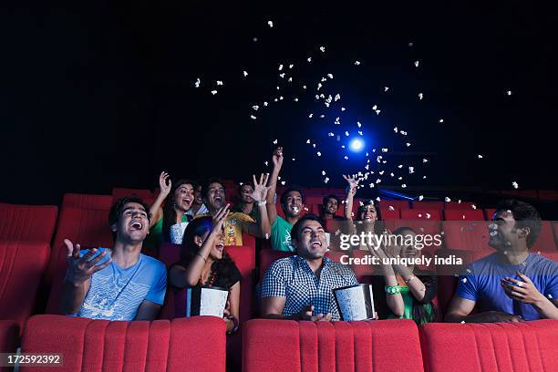 youngsters enjoying movie in a cinema hall - indian couple in theaters stock pictures, royalty-free photos & images