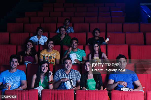 youngsters enjoying movie in a cinema hall - indian couple in theaters stock pictures, royalty-free photos & images