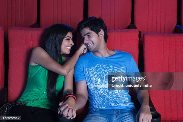 couple romancing in a cinema hall - indian couple in theaters - fotografias e filmes do acervo