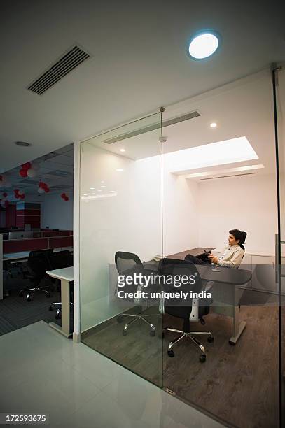 businessman sitting in his office - office cabin stockfoto's en -beelden