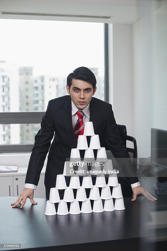 Portrait of a business looking satisfied after making a pyramid