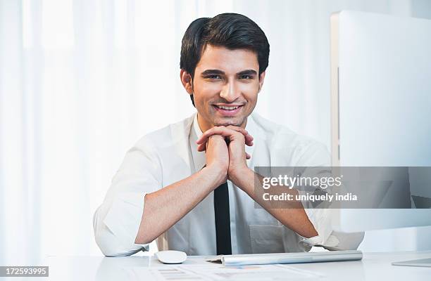 portrait of a businessman smiling - leaning on elbows stock pictures, royalty-free photos & images