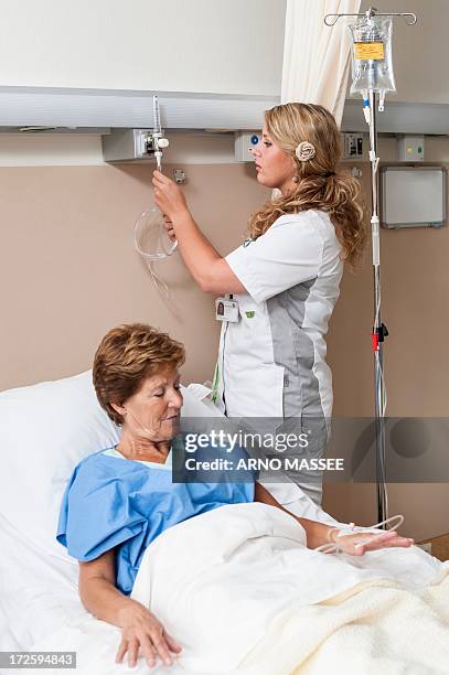 nurse preparing nasal cannula for patient - nasal cannula ストックフォトと画像