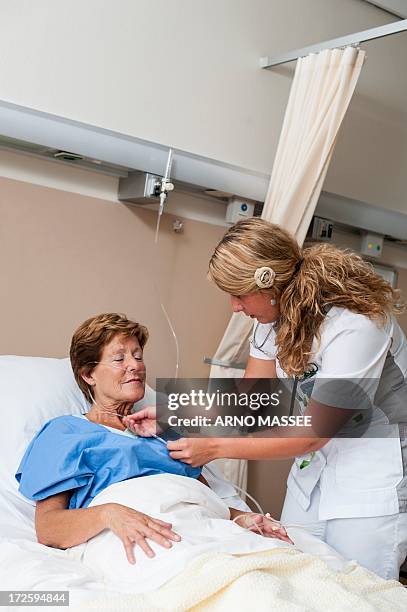 nurse preparing nasal cannula for patient - nasal cannula ストックフォトと画像