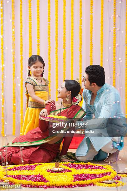 maharashtrian family making flower rangoli during ganesh chaturthi festival - preparations for ganesh chaturthi imagens e fotografias de stock