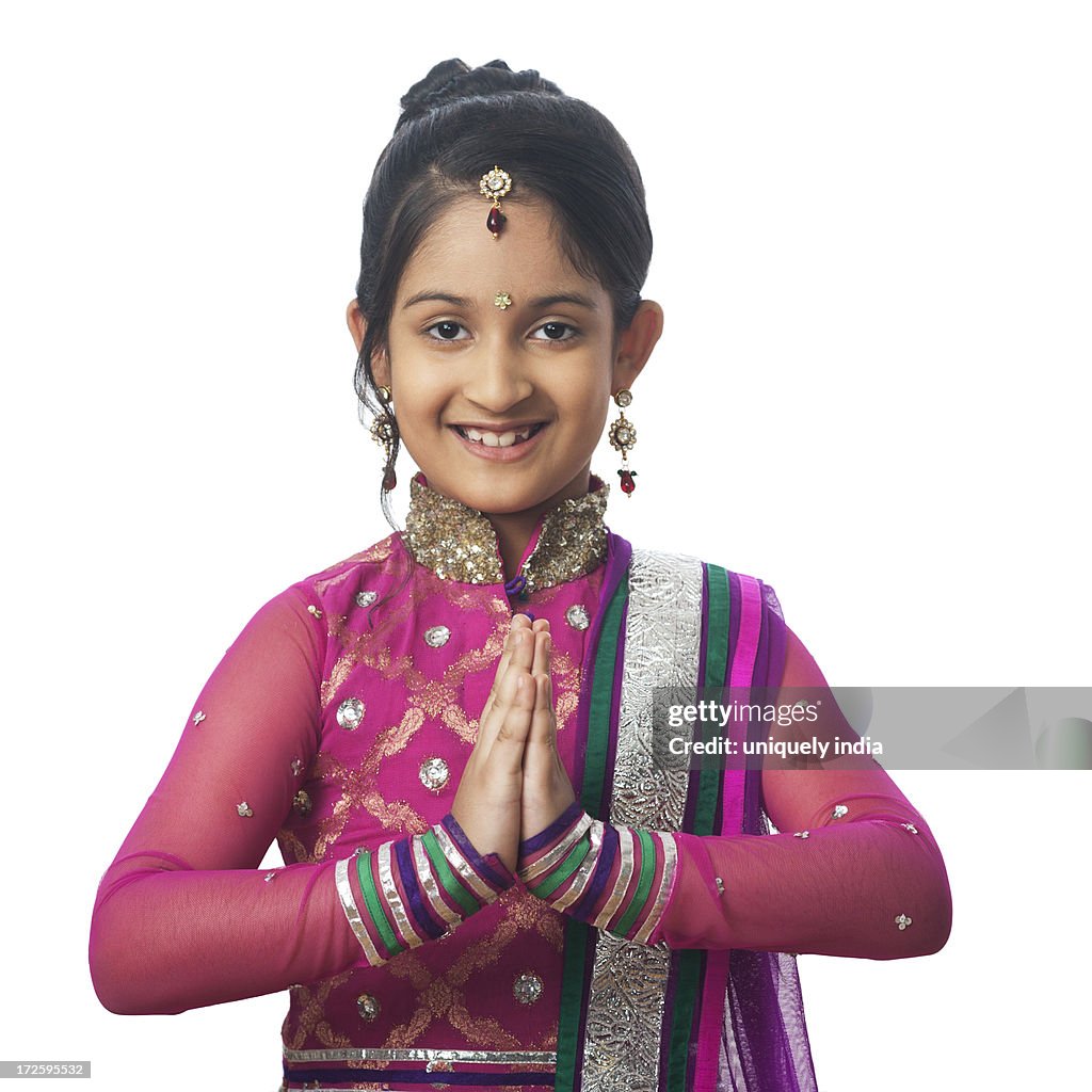 Portrait of a girl imitating like woman greeting on diwali